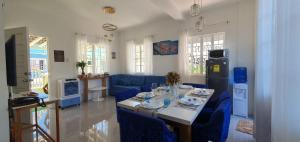 a living room with a table and blue chairs at Casa de M&I in General Santos