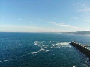 an aerial view of the ocean with a pier at APARTAMENTO MENCER in Malpica