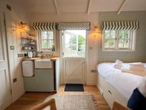 A kitchen or kitchenette at Shepherd's Hut at The Granary