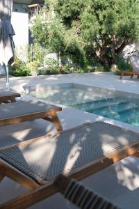 a swimming pool with two picnic tables at MAISON - ELEA in Ierissos