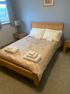 a bedroom with a bed with two towels on it at Polrudden in Orkney