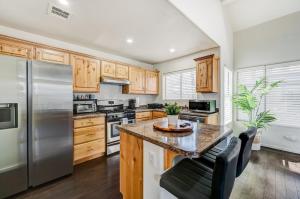 a kitchen with wooden cabinets and stainless steel appliances at Chic Vegas Retreat: Near Top Attractions in Las Vegas