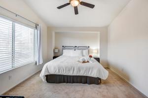 a bedroom with a bed with a ceiling fan at Chic Vegas Retreat: Near Top Attractions in Las Vegas