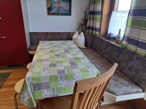 a table with a quilt on it in a living room at Holiday Home Moosen - NKI210 by Interhome in Neukirchen am Großvenediger