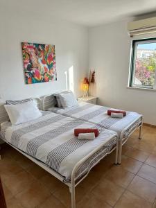 two beds sitting next to each other in a bedroom at Luz Paradise in Luz