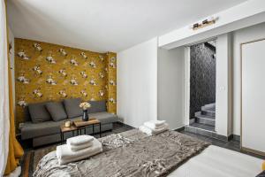 a living room with a couch and a yellow wall at 851 Suite Beautiful Superb Apartment in Asnières-sur-Seine