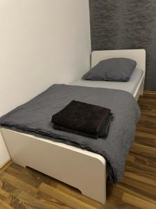 two beds in a white room with a blanket at Fair apartment 2 in Kelsterbach