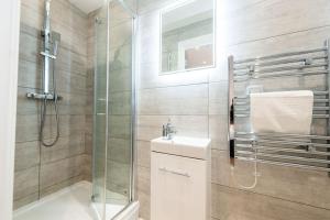 a bathroom with a shower and a toilet and a sink at Two Bedroom Duplex in Liverpool City Centre in Liverpool