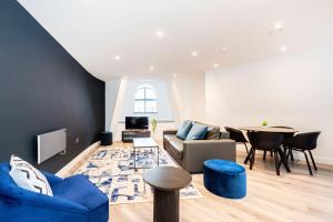 a living room with a couch and a table at Two Bedroom Duplex in Liverpool City Centre in Liverpool