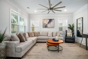 a living room with a couch and a ceiling fan at Lowcountry Lux 5 min to Beach 7 min to Dtwn in Charleston
