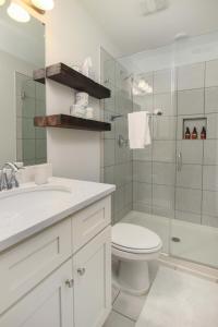 a bathroom with a toilet sink and a shower at Lowcountry Lux 5 min to Beach 7 min to Dtwn in Charleston