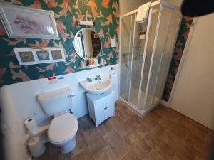 a bathroom with a toilet and a sink and a shower at Kirkcroft Guest House in Gretna