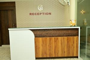 a reception desk in a room with a sign at Hotel Chanduka Palace , Puri in Puri