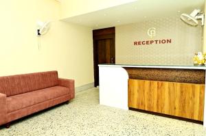 a waiting room with a couch and a reception counter at Hotel Chanduka Palace , Puri in Puri