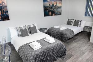 サウサンプトンにあるRefurbished House Long Stay Welcome Free Parkingのベッド2台(白いタオル付)が備わる客室です。