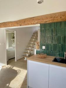 a kitchen with a spiral staircase in a house at Magnifique appartement + terrasse au cœur d’Aix in Aix-en-Provence