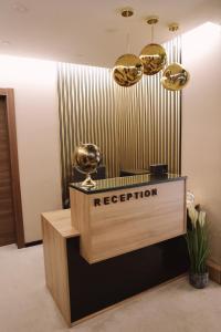 a reception desk in a lobby with gold chandeliers at Sax-Win in Požega