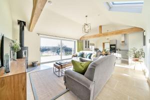 a living room with a couch and a table at Yawlings in Holditch