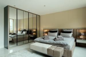 a bedroom with a large bed and a large mirror at Lux.41 in Berlin