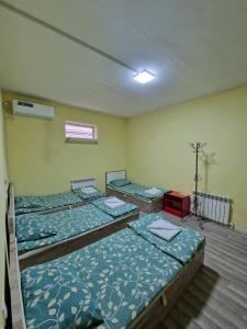 a room with three beds in a room at Stay hostel in Tashkent