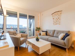 a living room with a couch and a table at Apartment Le Garden Fleuri by Interhome in Blonville-sur-Mer