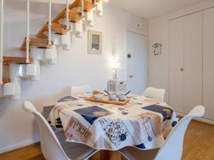 a white dining room with a table and chairs at Apartment Le Garden Fleuri by Interhome in Blonville-sur-Mer +15 photos
