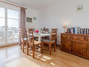 a dining room with a table and chairs and a window at Apartment Le Manoir by Interhome in Cabourg