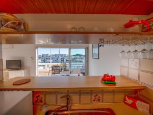 a kitchen with a counter with a view of a dining room at Apartment Les Régates by Interhome in Le Grau-du-Roi