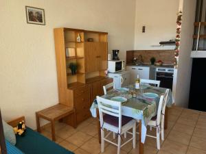 a kitchen with a table and chairs and a kitchen with a table and a table at Apartment Les Saladelles-8 by Interhome in Le Grau-du-Roi