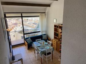 a living room with a couch and a table at Apartment Les Saladelles-8 by Interhome in Le Grau-du-Roi