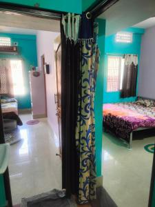 uma sala com um quarto com uma cama em jharana guest house em Puri