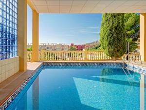 a swimming pool in front of a building at Apartment Raquel by Interhome in Calpe