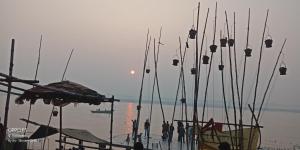 a group of people standing on a beach with fishing nets at Hotel Gokul Grand in Varanasi