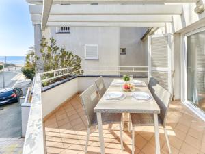a table and chairs on the balcony of a house at Apartment Platja de Roses-8 by Interhome in Roses