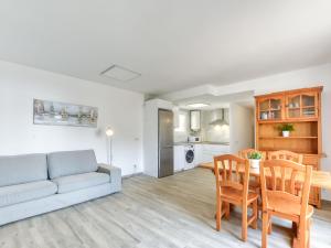 a living room with a couch and a table and chairs at Apartment Platja de Roses-3 by Interhome in Roses