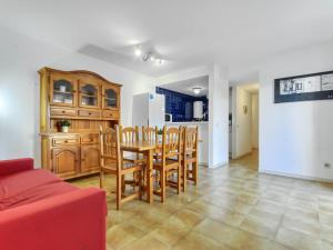 a kitchen and dining room with a table and chairs at Apartment Platja de Roses-9 by Interhome in Roses