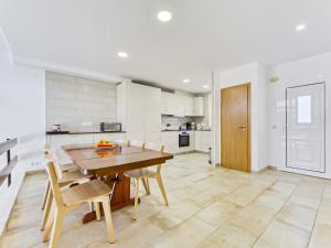 a large kitchen with a wooden table and chairs at Holiday Home Port Emporda by Interhome in Empuriabrava