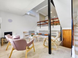 a living room with chairs and a table and a staircase at Holiday Home Port Emporda by Interhome in Empuriabrava