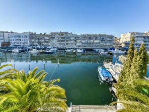 a marina with boats in the water and buildings at Holiday Home Port Emporda by Interhome in Empuriabrava