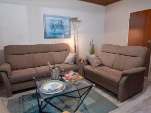 a living room with two couches and a coffee table at Holiday Home Albatross by Interhome in Norddeich +38 photos