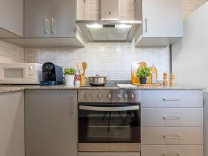 - une cuisine avec des placards blancs et une cuisinière dans l'établissement Holiday Home Gaviota 9 by Interhome, à Riumar