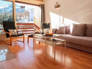 a living room with a couch and a table at Apartment Rosablanche A24 by Interhome in Siviez