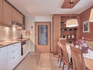 a kitchen with a table and chairs and a dining room at Holiday Home Wiese by Interhome in Oberlehn