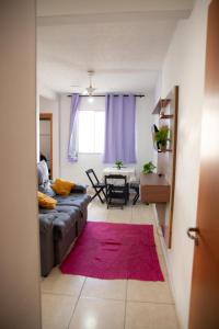 a living room with a couch and a red rug at Apto otima localizacao e Wi-Fi em Serra ES in Serra