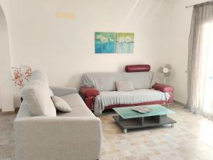 a living room with a couch and a coffee table at Holiday Home Benicadim-1 by Interhome in Beniarbeig