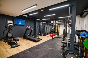 a gym with several treadmills and exercise machines at Apartamenty Laguna Beskidów - B35 in Zarzecze