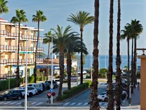a street with palm trees and a parking lot at Apartment L'Ancora by Interhome in Jávea