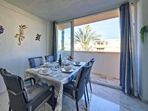a dining room with a table and chairs and a large window at Apartment L'Ancora by Interhome in Jávea