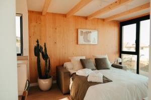 Un dormitorio con una cama grande y un cactus en ESPAZO NATURE en Carballo