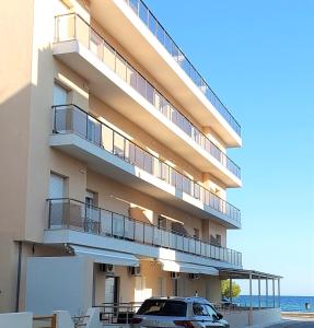 a building with a car parked in front of it at Navarino Luxe Suites in Perea +37 photos